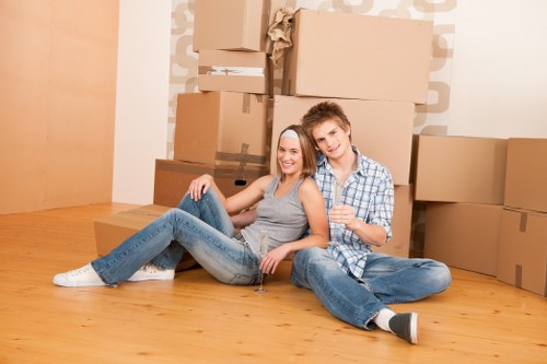 Professional movers carrying furniture from a local Hounslow property