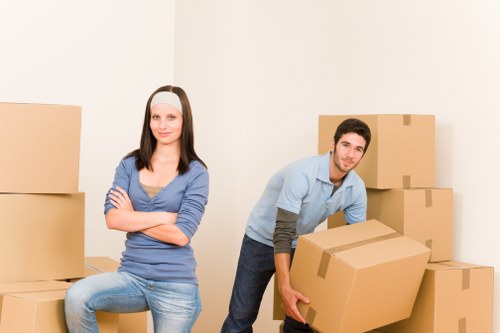 Movers unloading boxes and furniture at a property in Hounslow